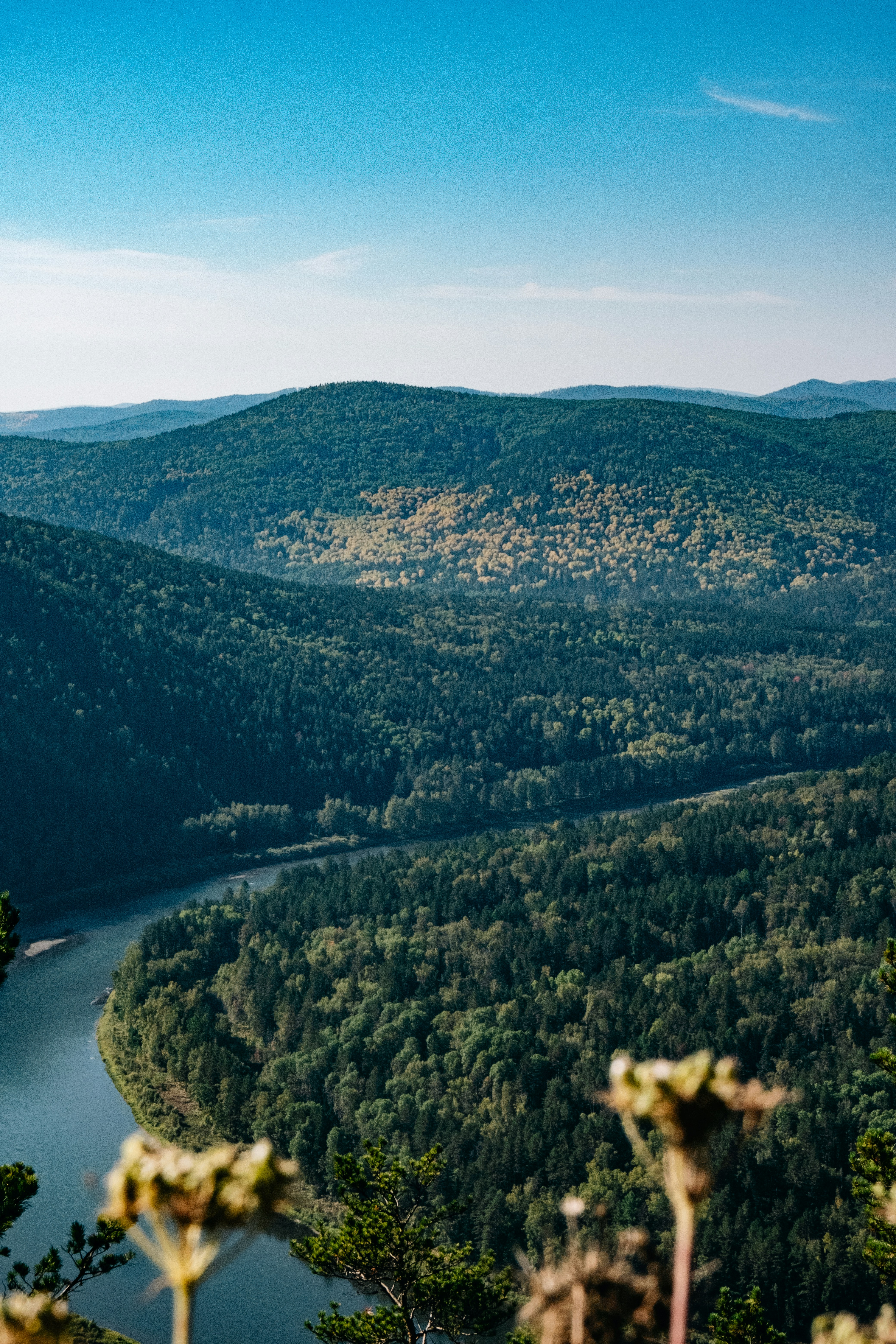 a scenic view of a river surrounded by mountains