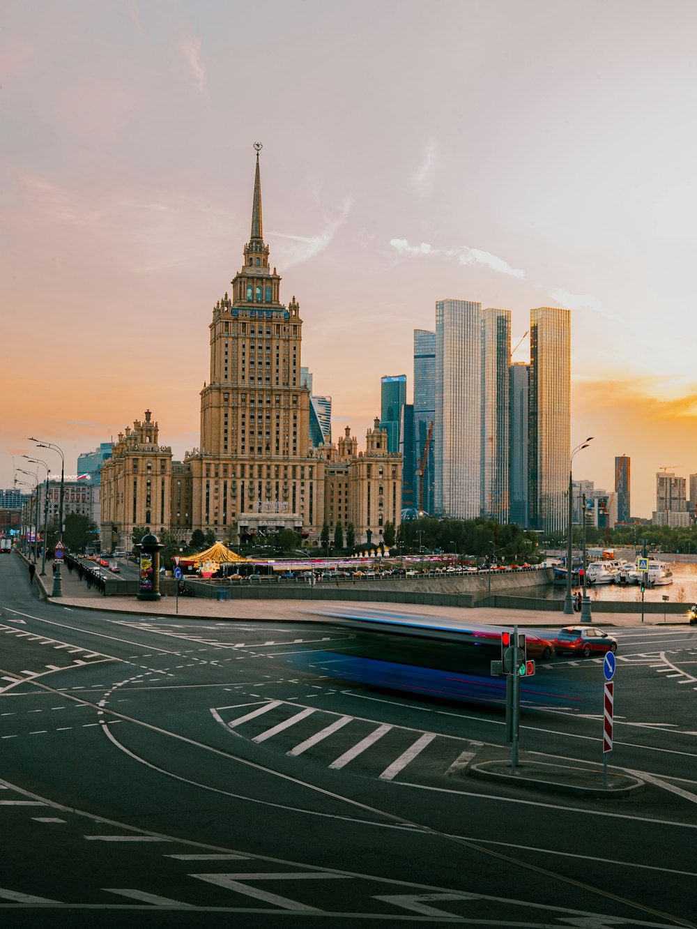 a bus driving down a street next to tall buildings