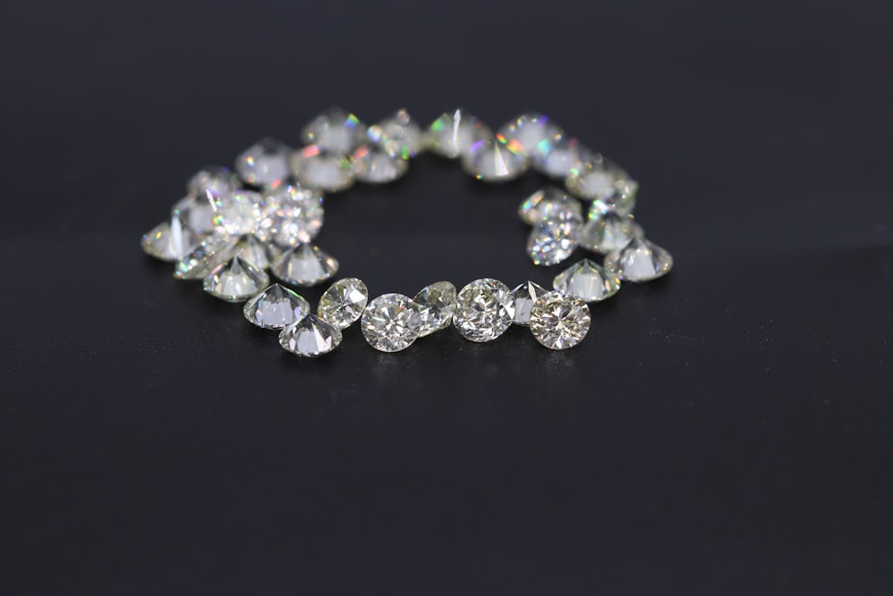 a diamond bracelet on a black surface