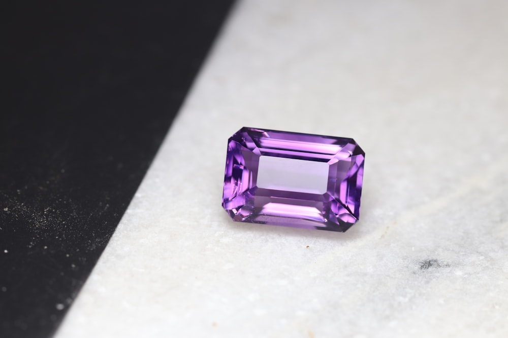 a purple stone sitting on top of a white counter