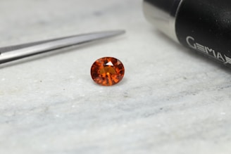 a close up of a diamond near a pair of scissors