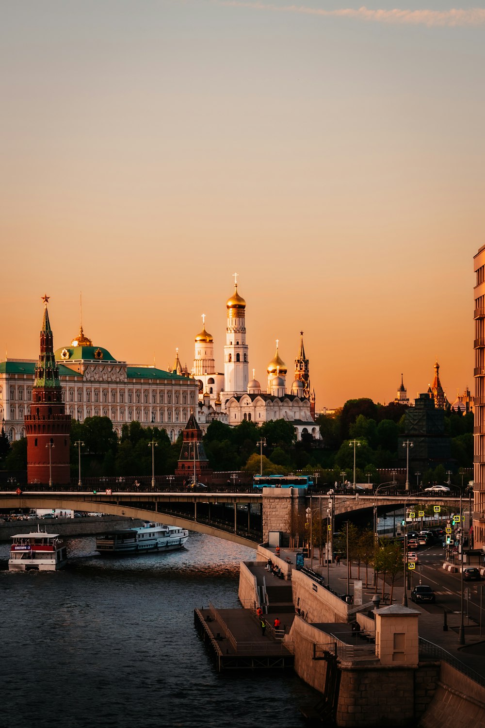 a river with a bridge and buildings in the background