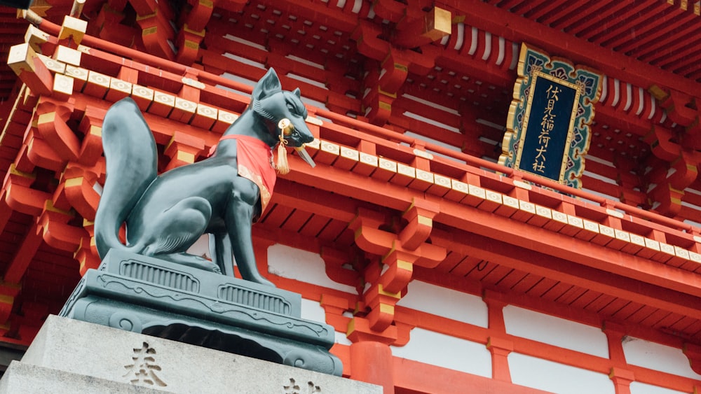 a statue of a dog in front of a building