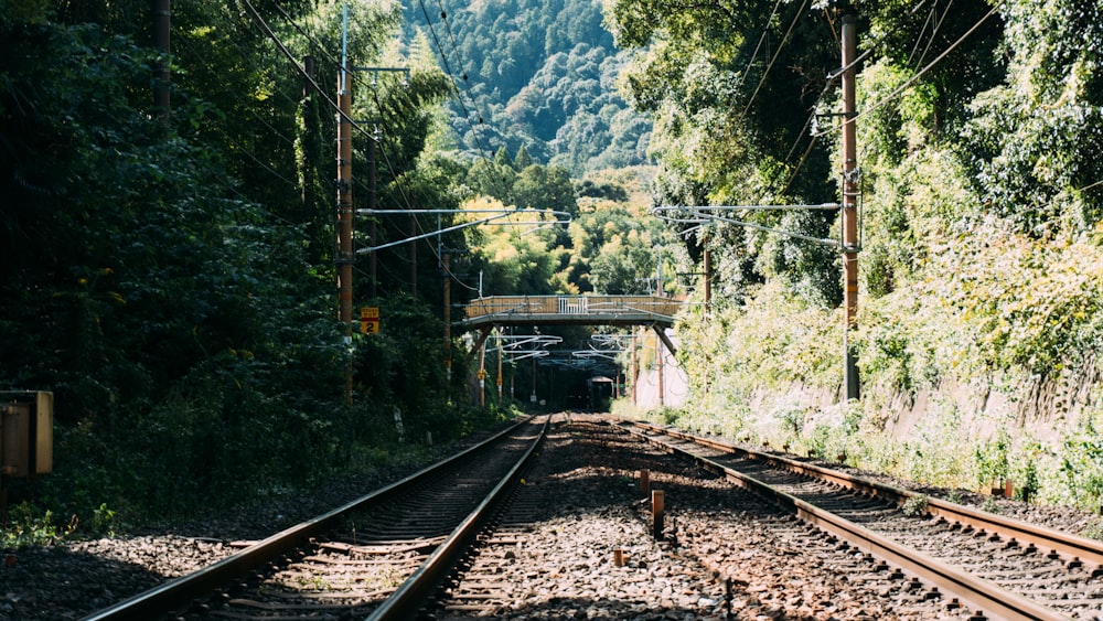 a train track with a bridge in the background