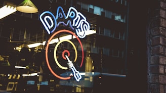 a store window with a neon sign in the window