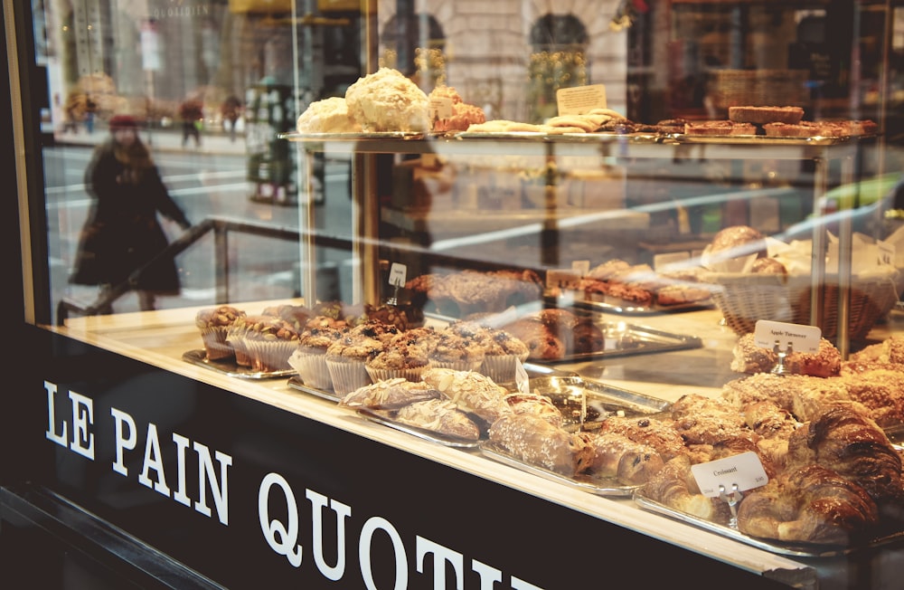a bakery window filled with lots of pastries