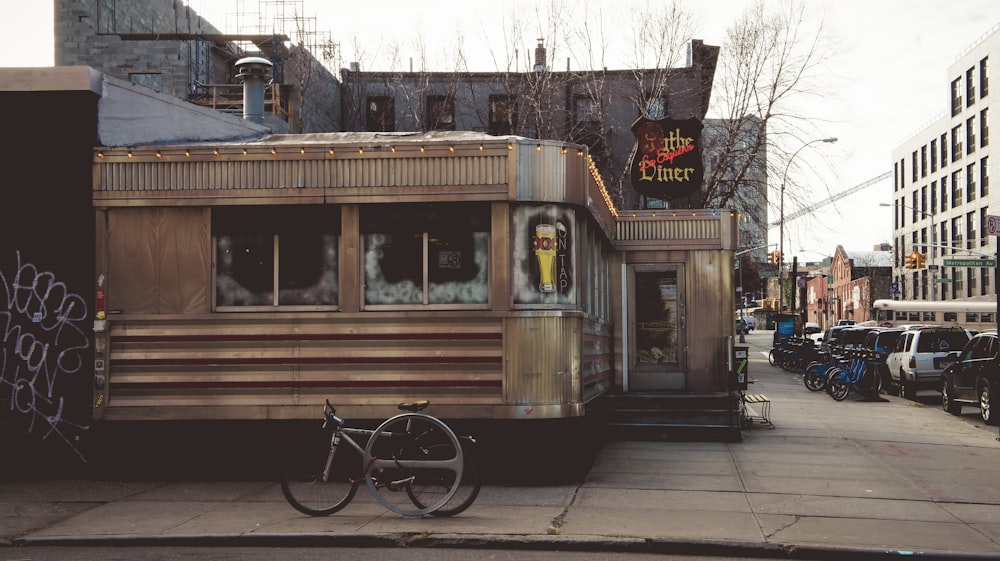 a bike parked next to a train car on a city street