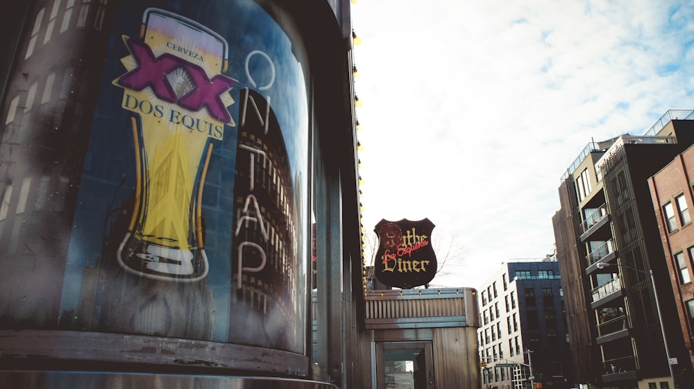 a beer sign on a building in a city