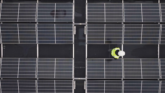 a person standing in front of a large array of solar panels