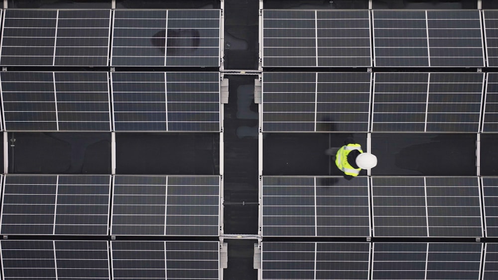 a person standing in front of a large array of solar panels