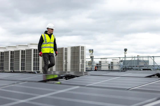 HVAC technician inspecting rooftop air conditioning equipment