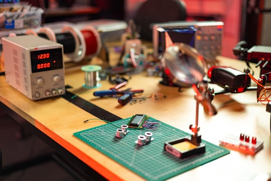 a table topped with lots of electronics on top of a wooden table