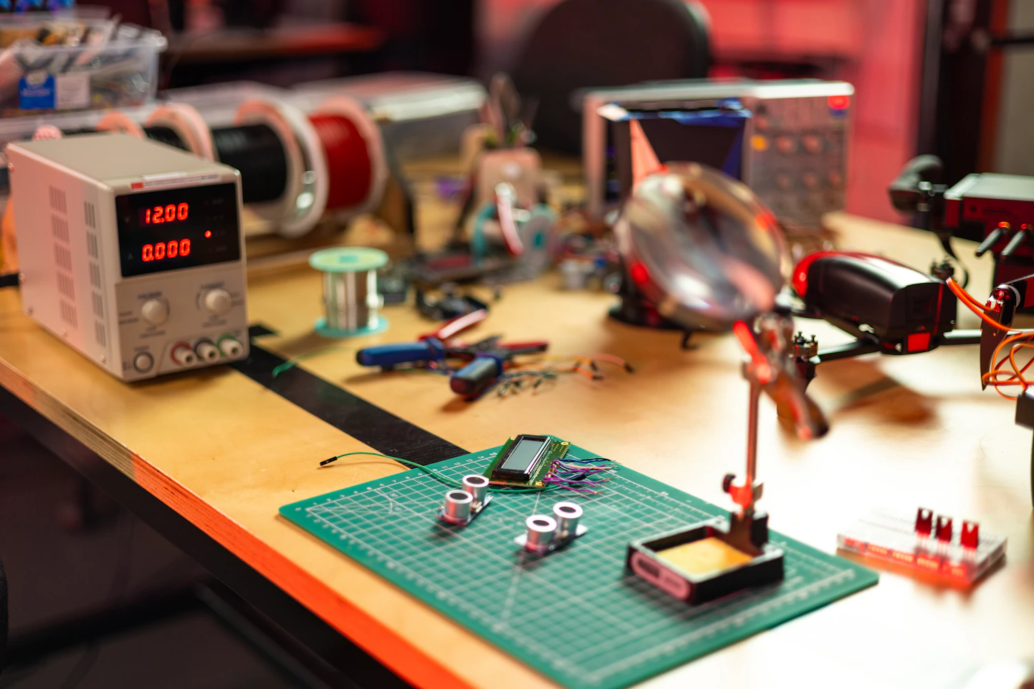 The Nightglass workbench in Kiruna, covered with audio boards, meters and hand tools