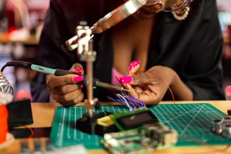 a woman is working on a piece of art