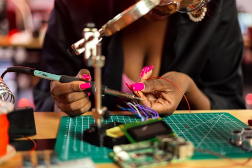 a woman is working on a piece of art