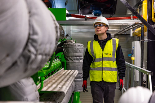 Worker wearing safety vest and safety glasses