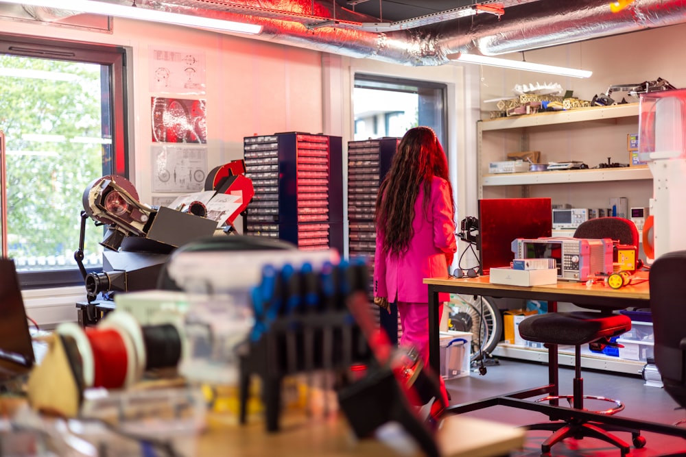 a woman standing in a room with lots of crafting supplies