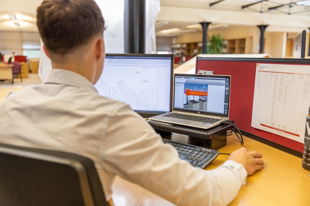 a man sitting at a desk in front of a computer