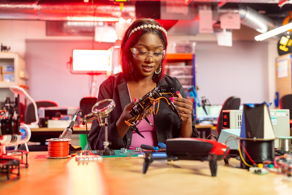 a woman looking at a piece of electronic equipment