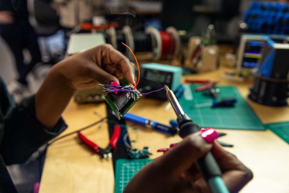 a person is working on a piece of wire