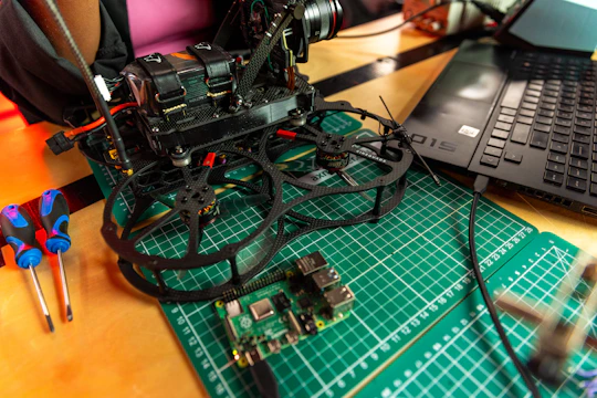 a camera sitting on top of a table next to a laptop