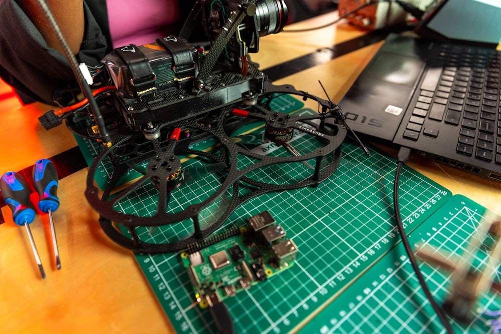 a camera sitting on top of a table next to a laptop