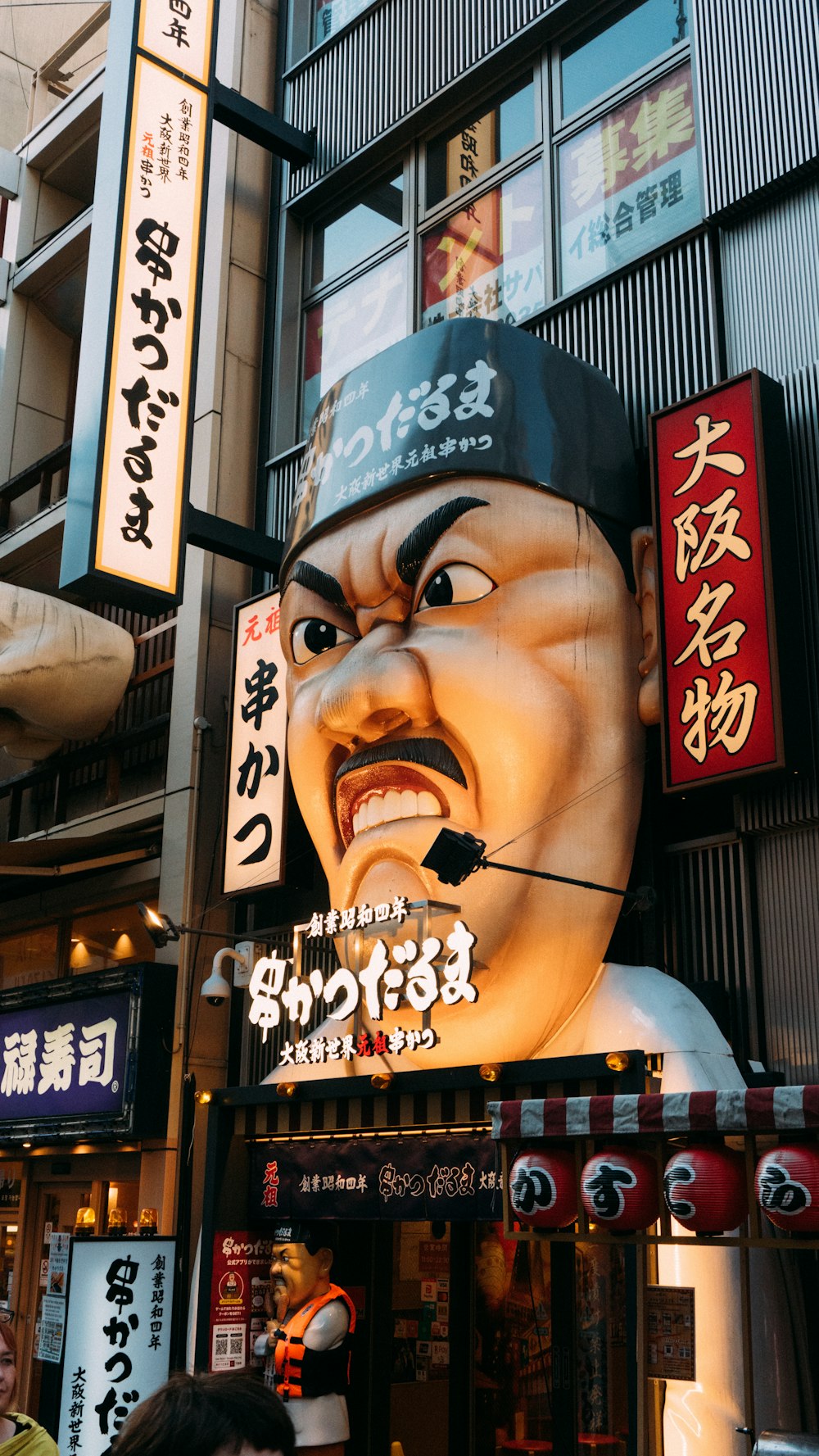 a giant statue of a man with a hat on his head