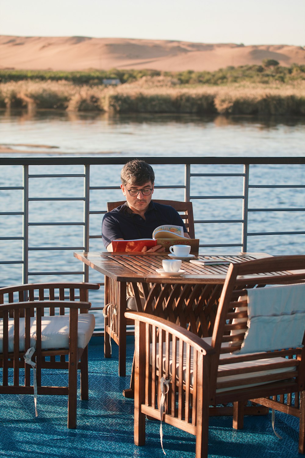 a man sitting at a table on a boat