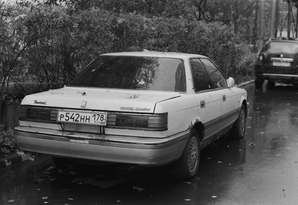 a car parked on the side of the road in the rain