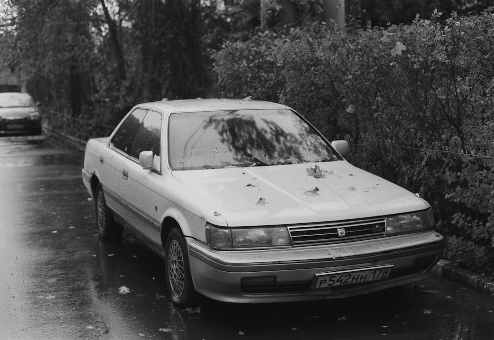 a car parked on the side of the road in the rain