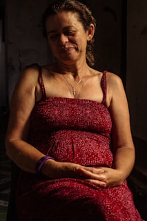 a woman in a red dress sitting down