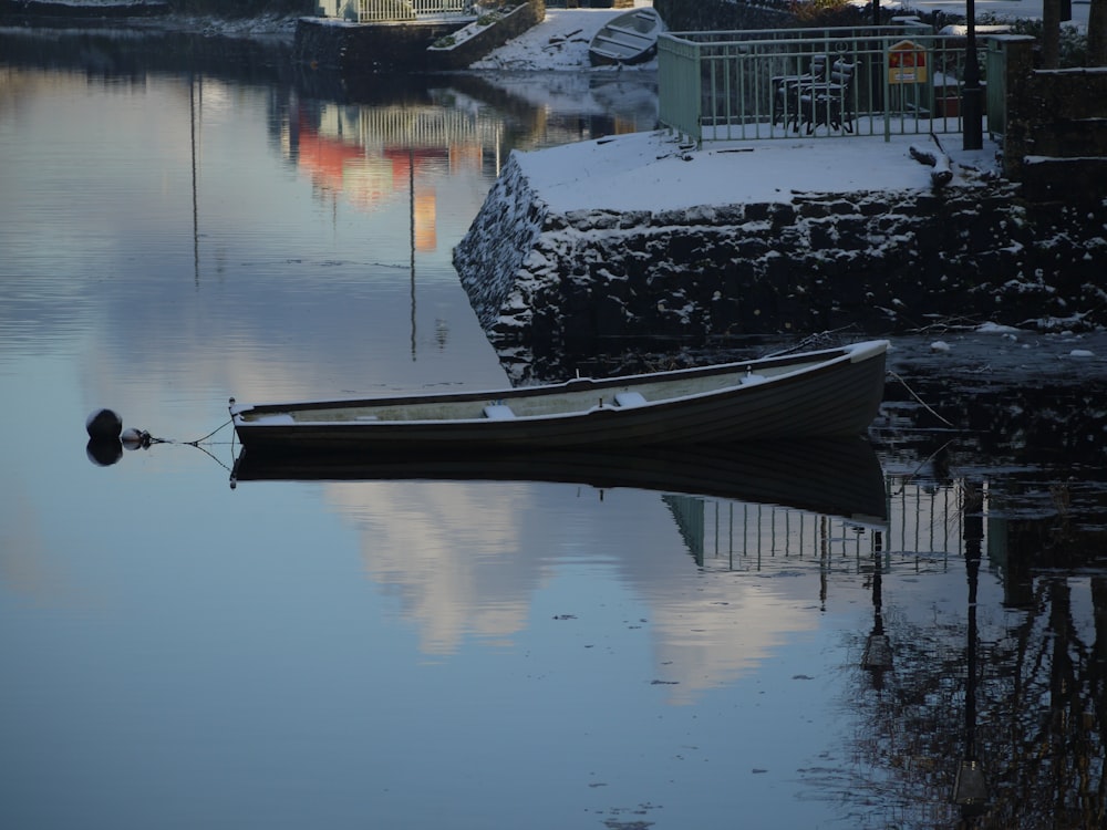 a small boat floating on top of a body of water