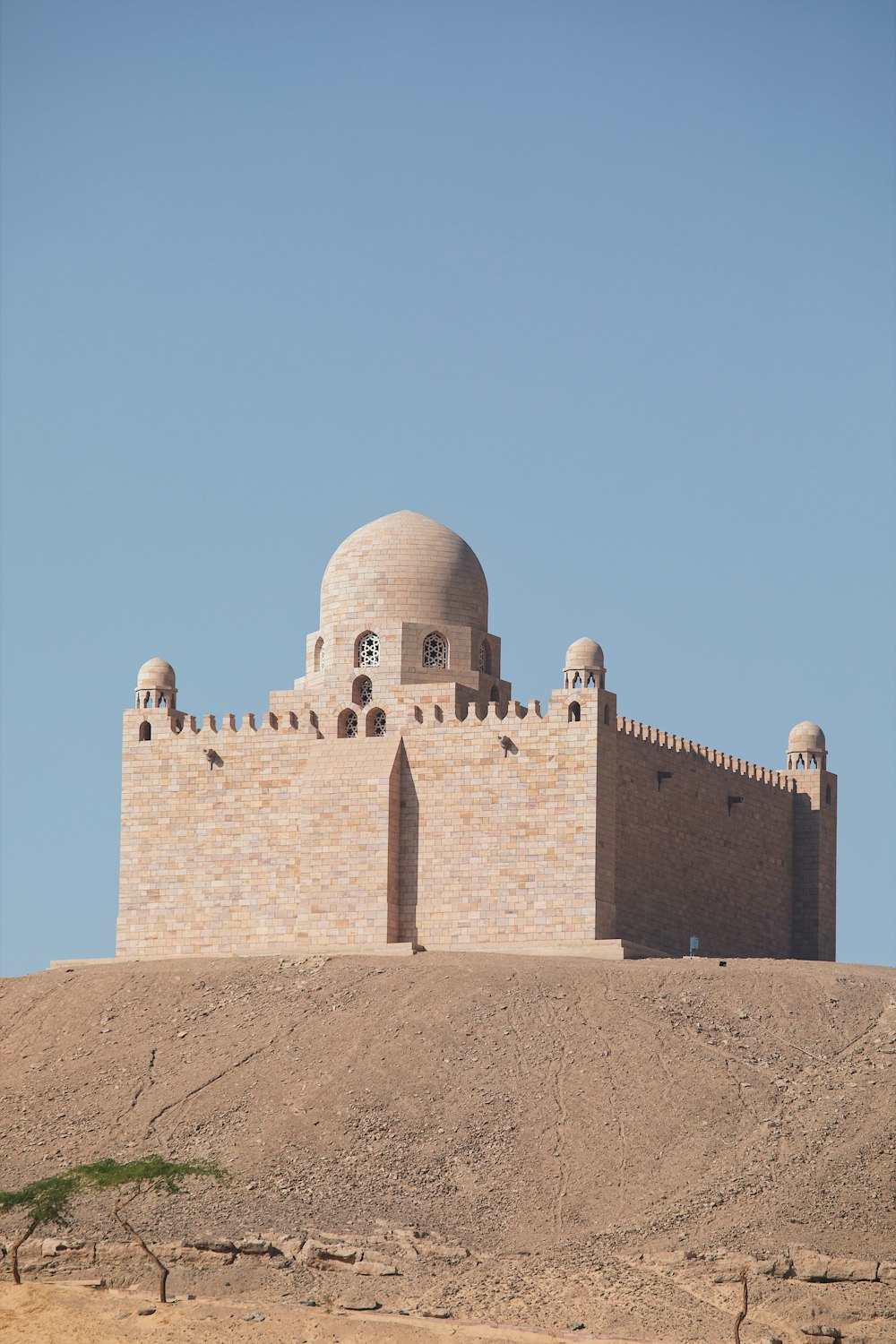 a large brick building on top of a hill