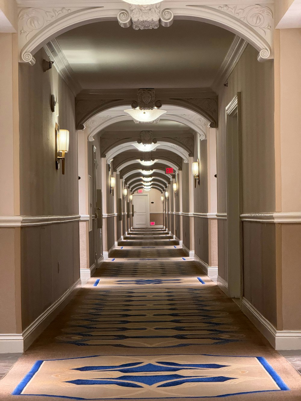 a long hallway with a blue and white design on the floor