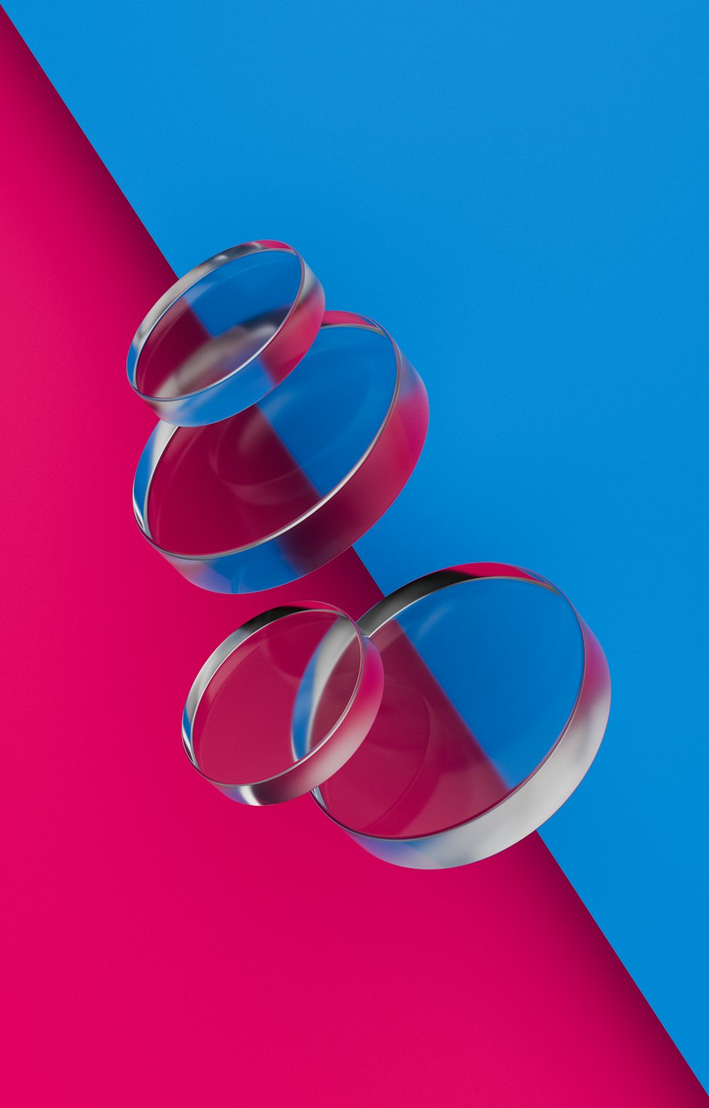 a pair of glasses sitting on top of a pink and blue background