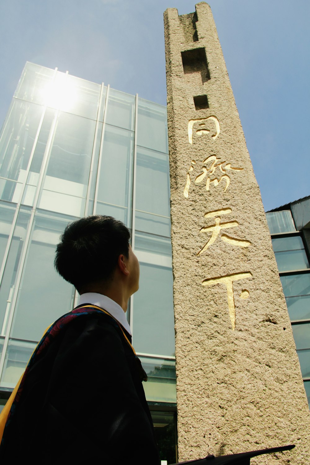 a man standing in front of a tall building