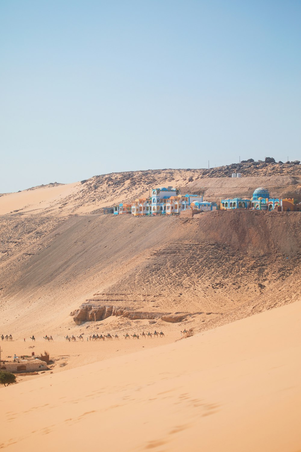 a group of houses on a hill in the desert
