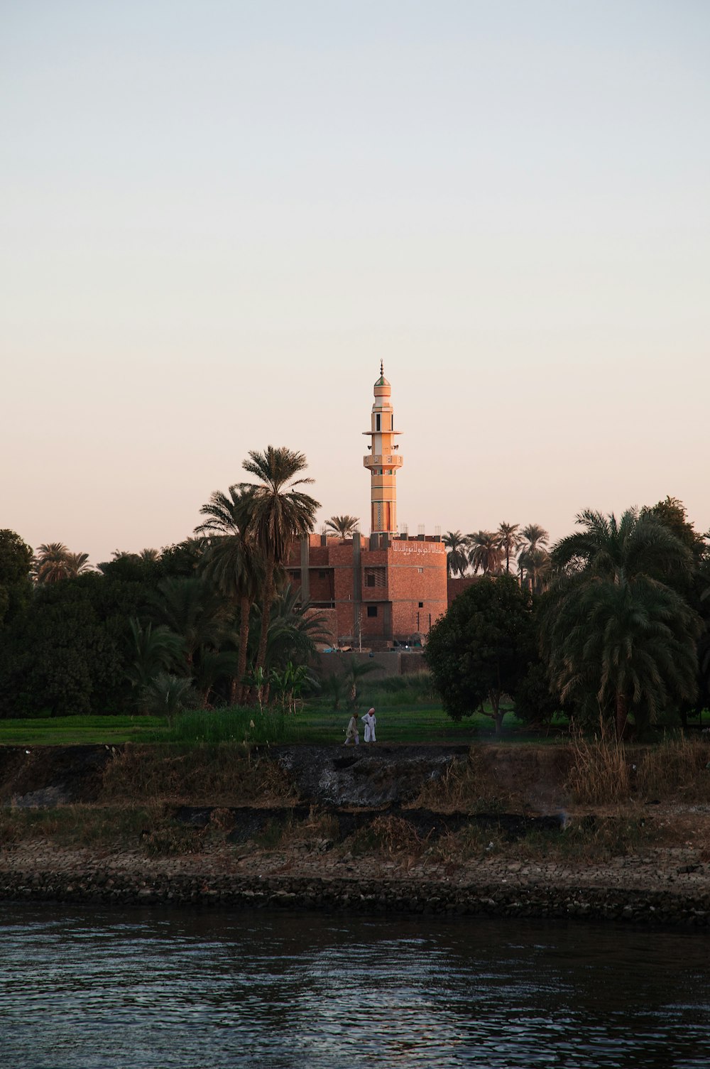 a tall tower sitting on top of a lush green field