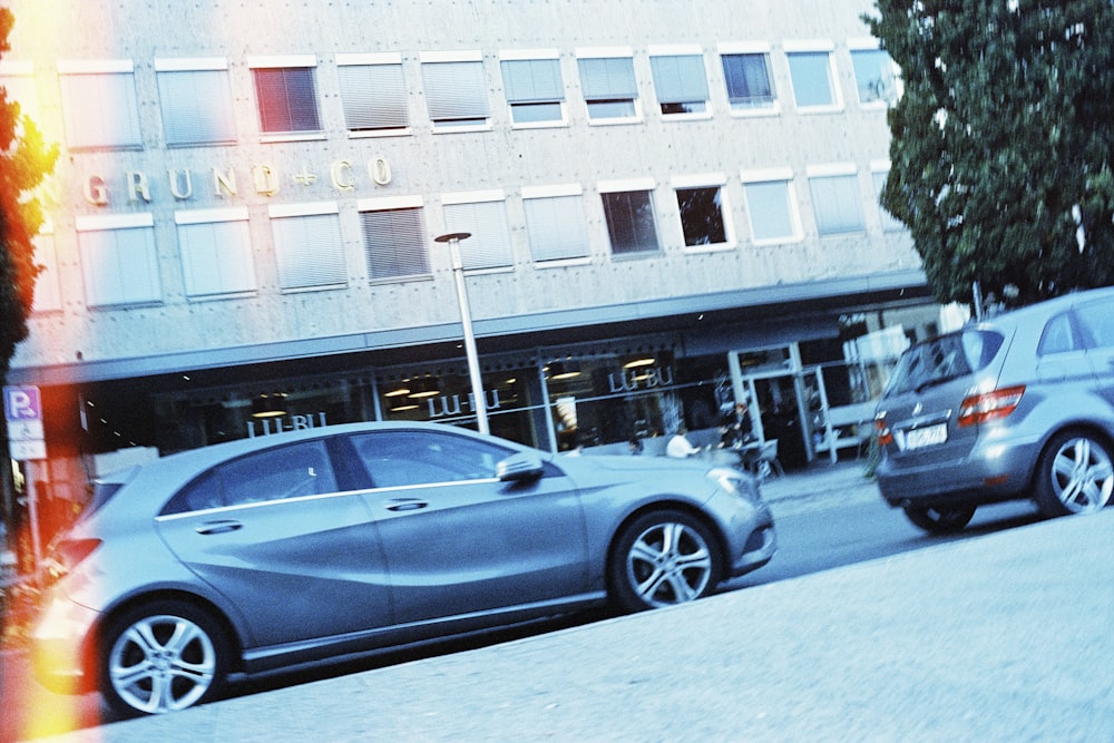 a couple of cars that are parked in front of a building