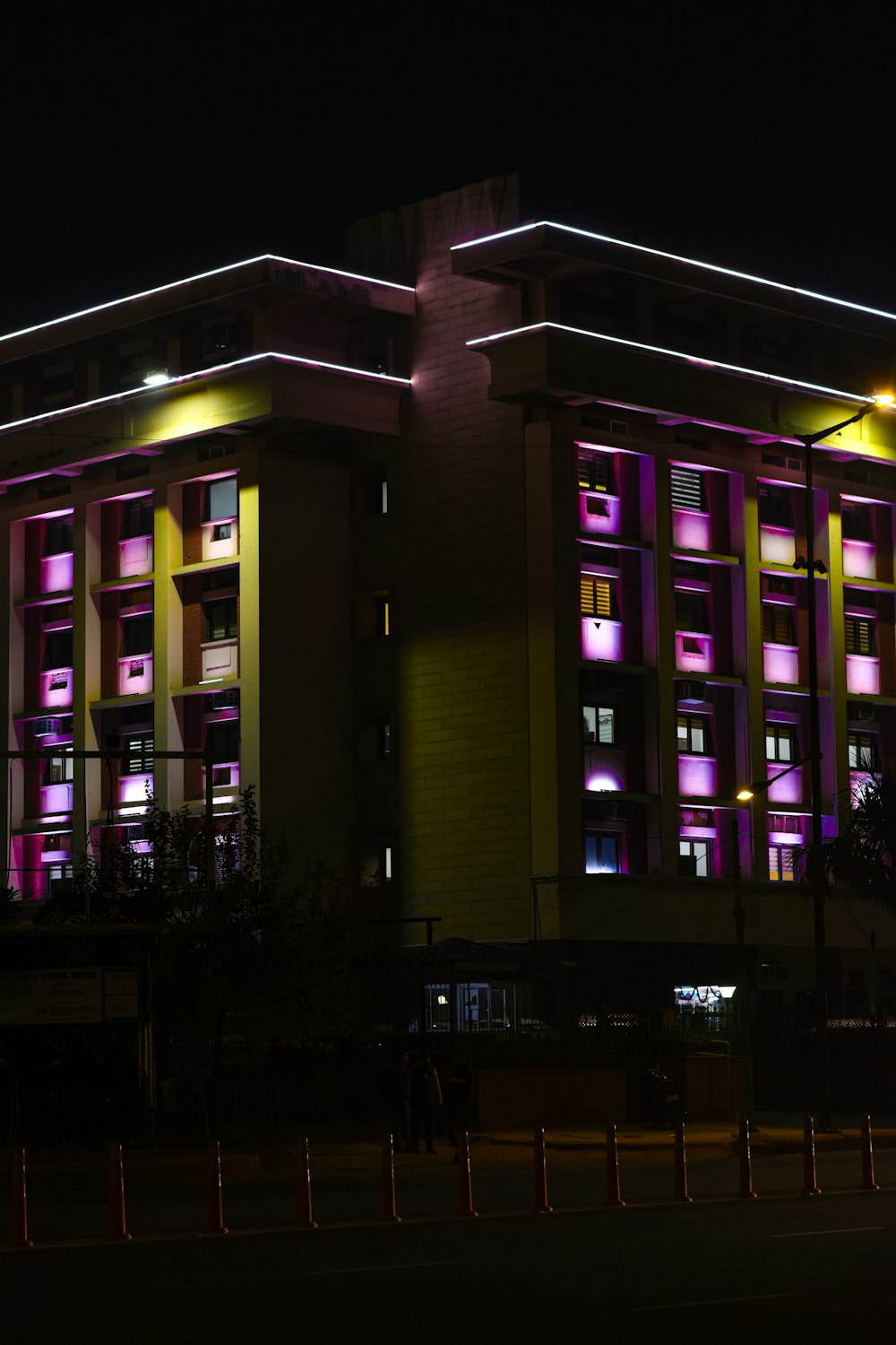 a large building lit up with purple and yellow lights