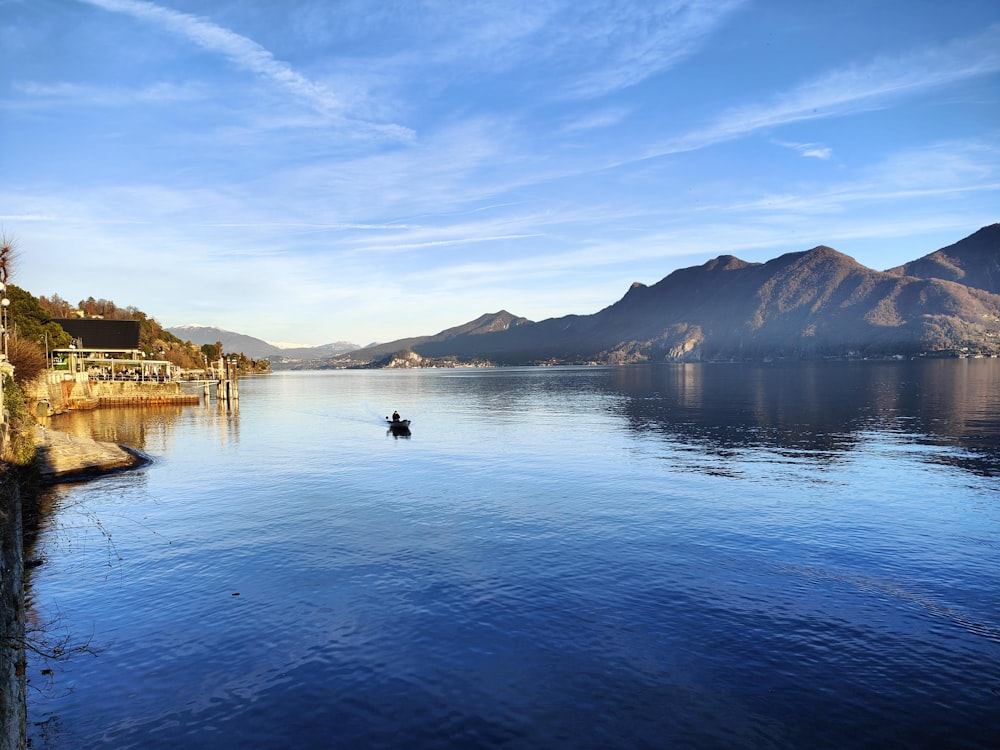 a person in a small boat on a large body of water