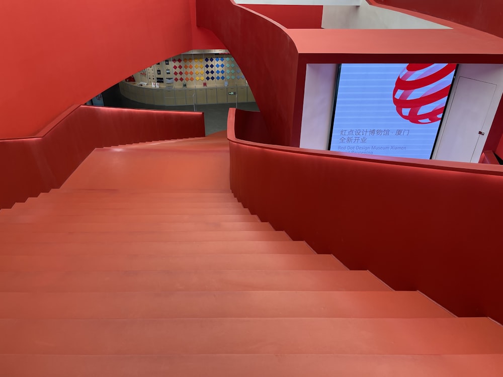 a red staircase with a tv on it