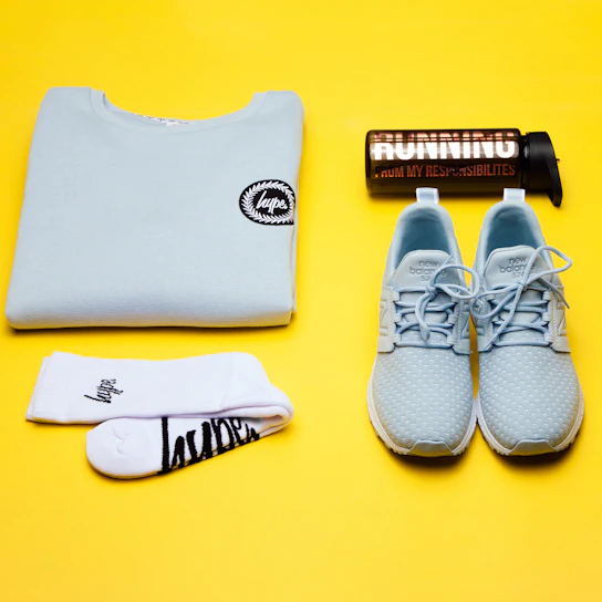 a pair of running shoes, a bottle of water, and a pair of socks