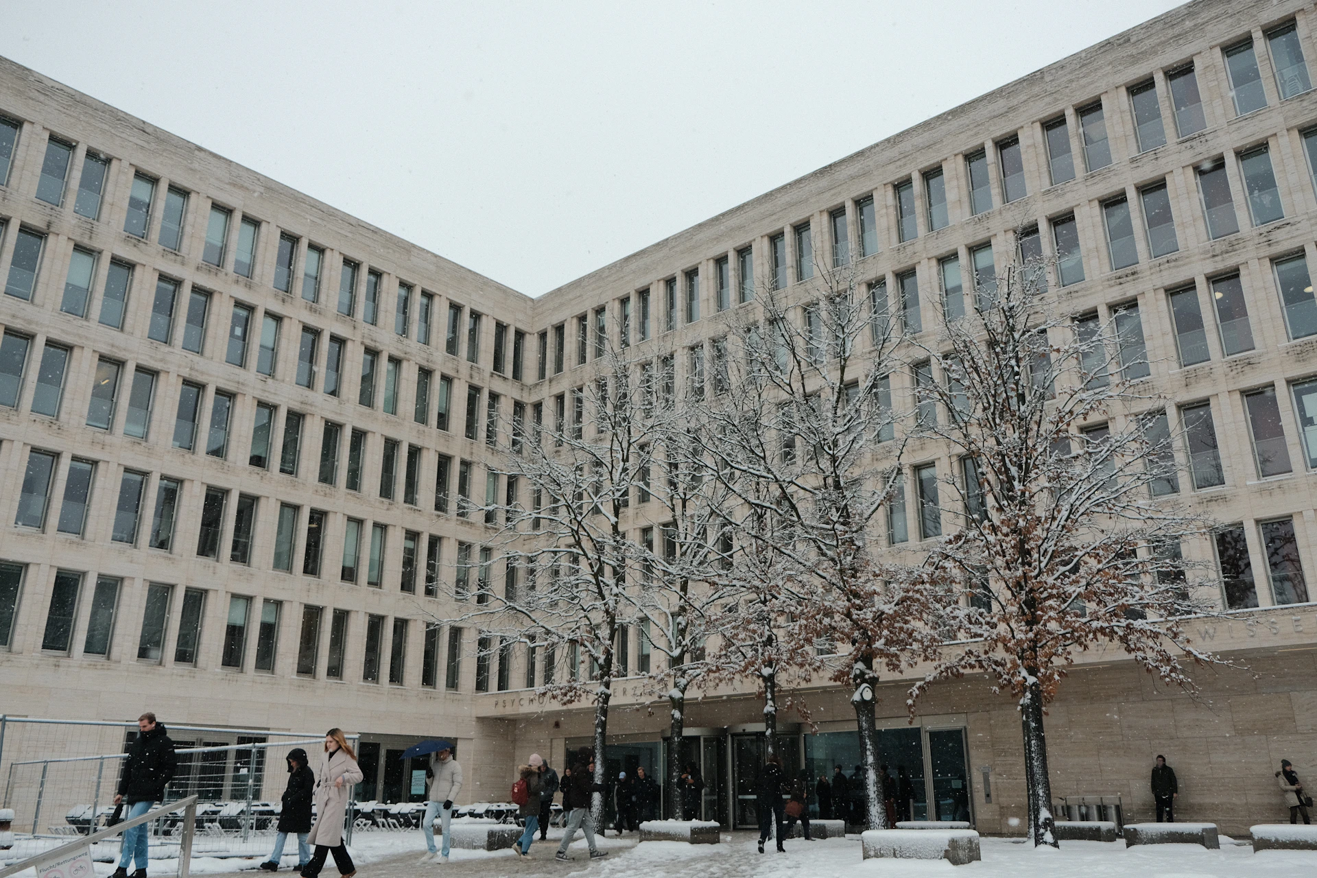 a group of people walking in front of a building