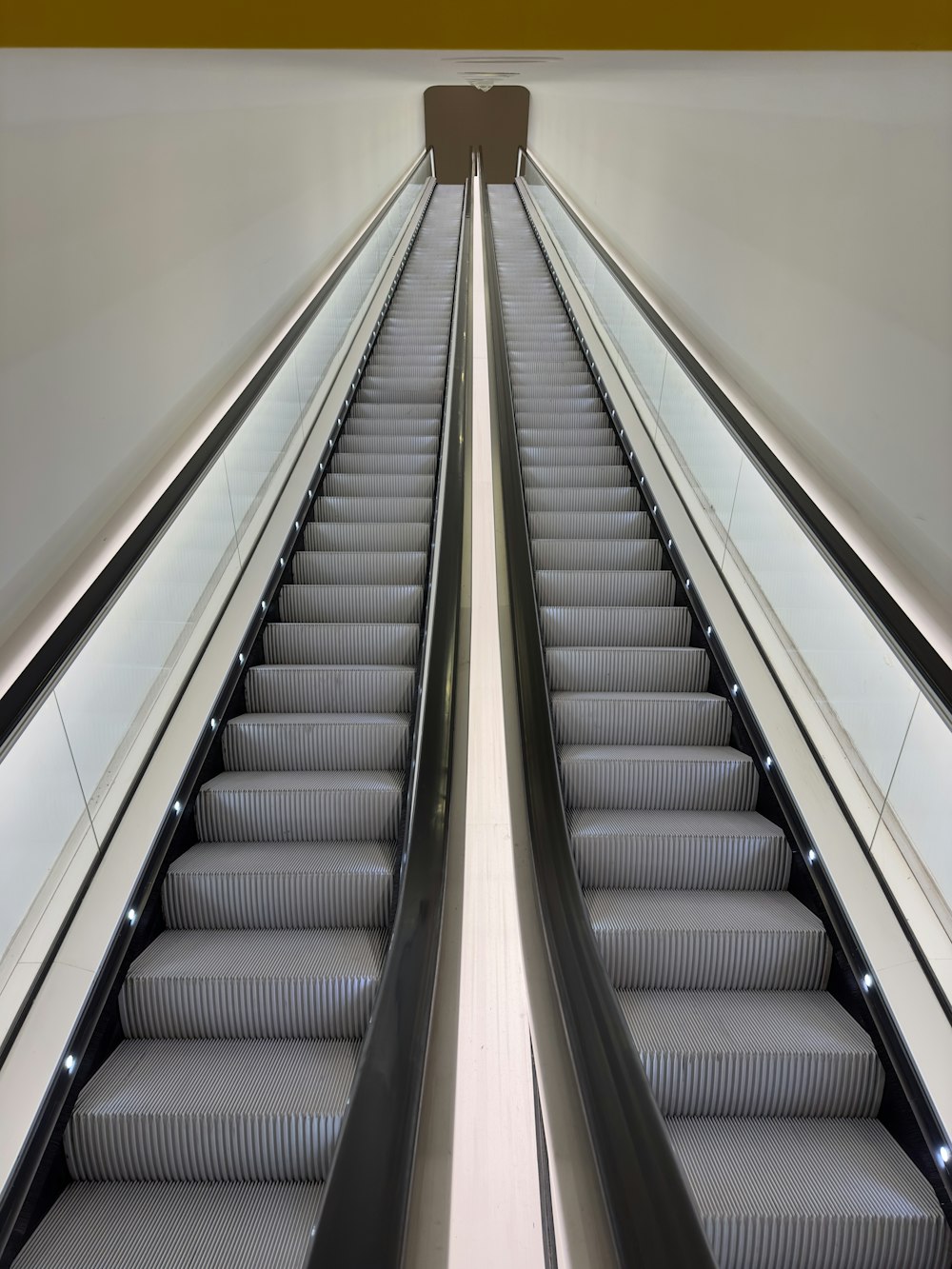 an escalator in a building with a bunch of stairs