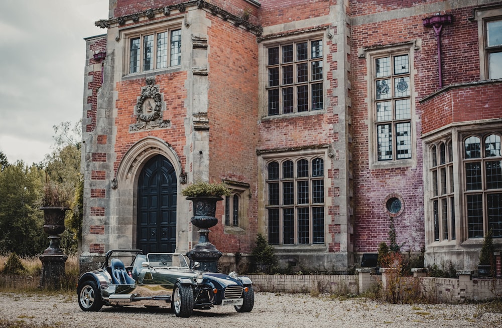 a car parked in front of a large brick building