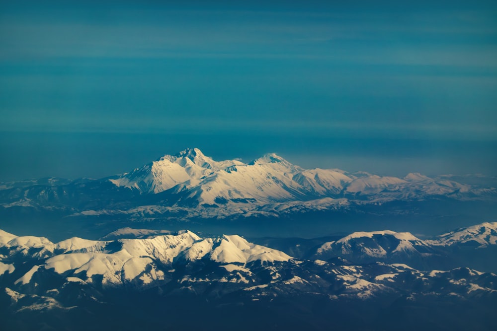 a view of snow covered mountains from an airplane