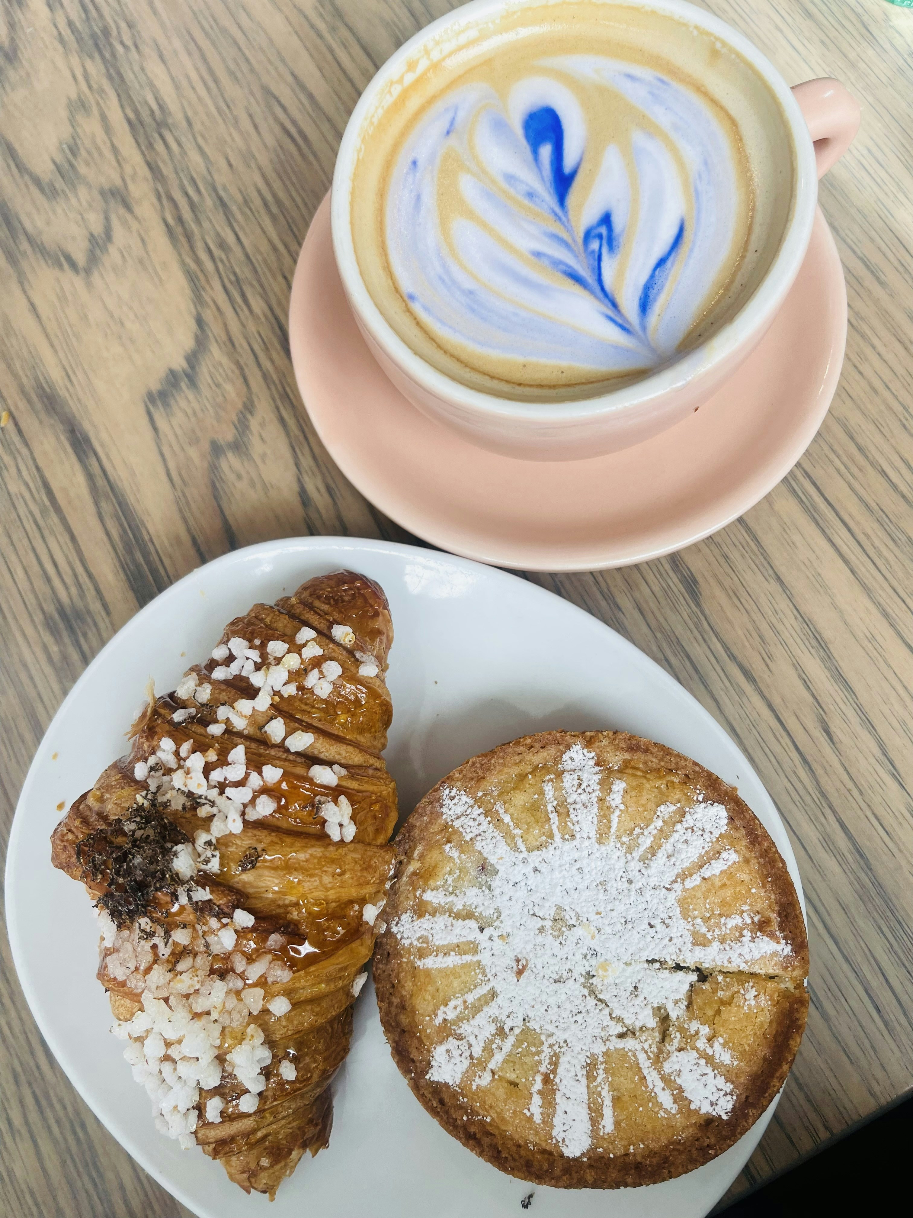 A delicious combination of a hot coffee and a fresh pastry
