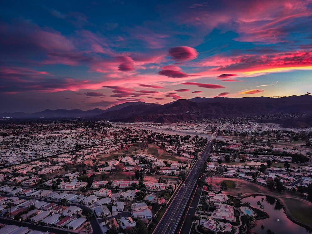 an aerial view of a city at sunset