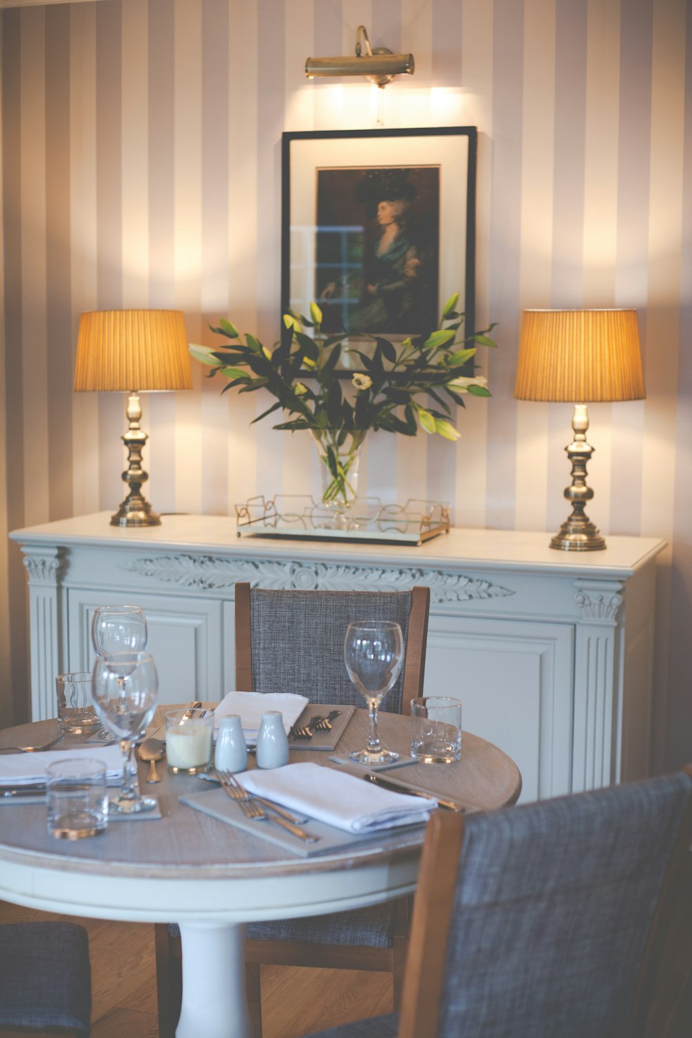 a dining room table with a vase of flowers on top of it